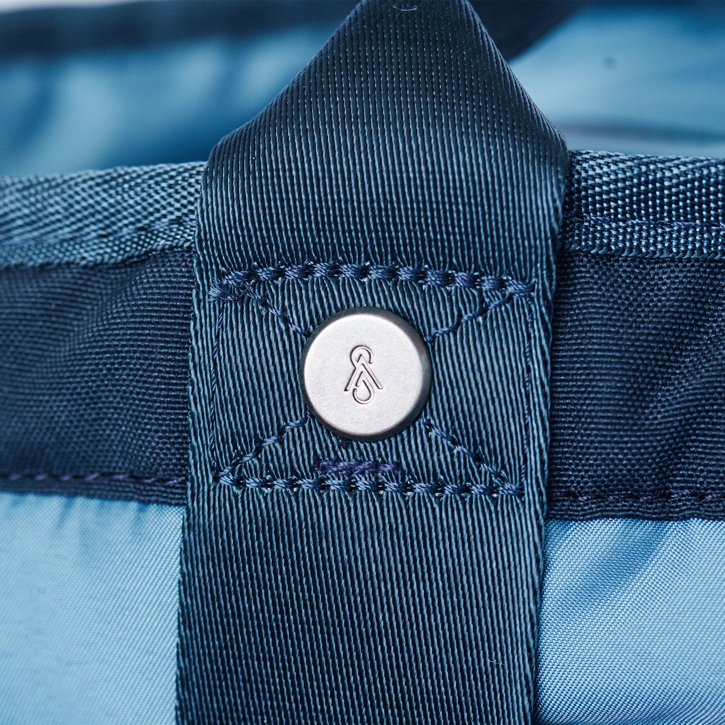 metal rivet with SMMT logo on tote bag strap