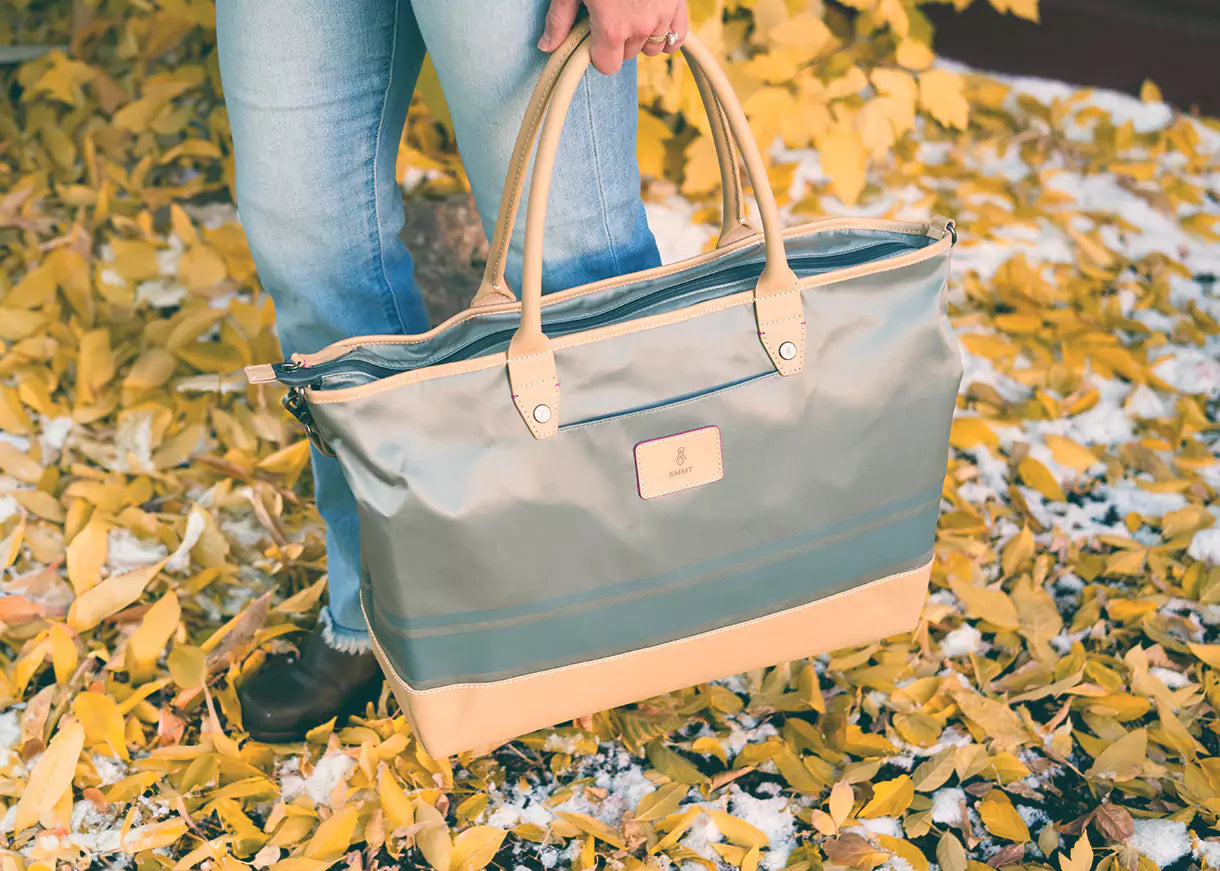 closeup of woman carrying high end bag downtown in fall